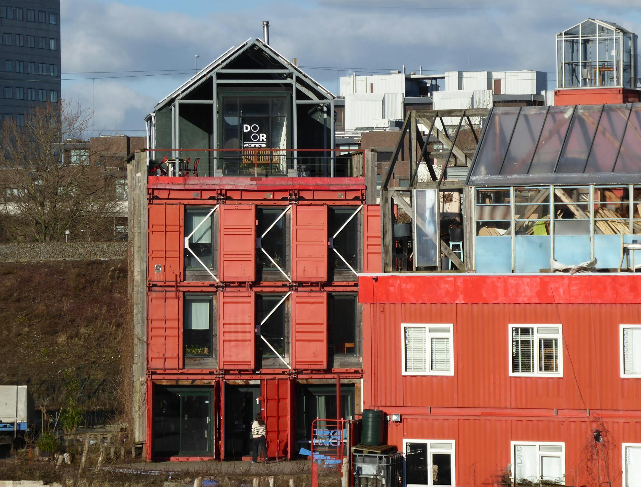 Unique shipping container buildings in Amsterdam showcasing innovative urban architecture.